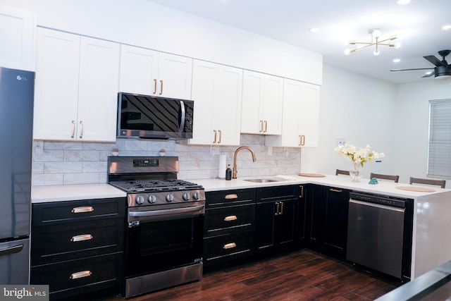 kitchen with light countertops, appliances with stainless steel finishes, and white cabinets