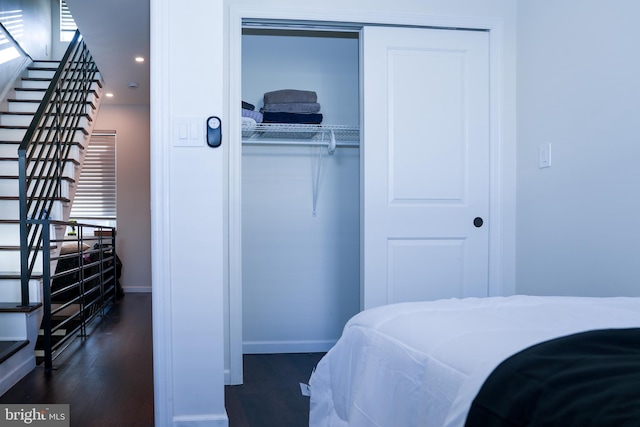 bedroom with baseboards, dark wood-type flooring, a closet, and recessed lighting