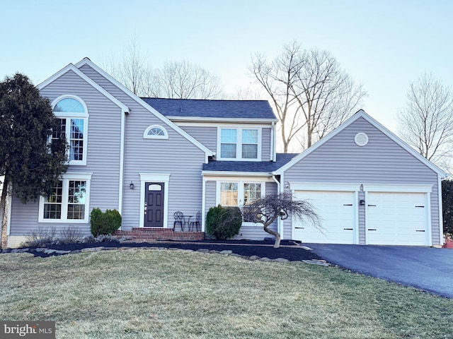 traditional-style home featuring a garage, roof with shingles, aphalt driveway, and a front lawn