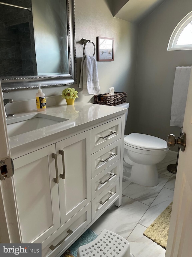 bathroom featuring marble finish floor, vanity, and toilet