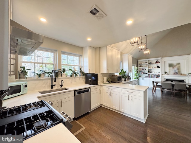 kitchen featuring a chandelier, white microwave, a sink, visible vents, and stainless steel dishwasher