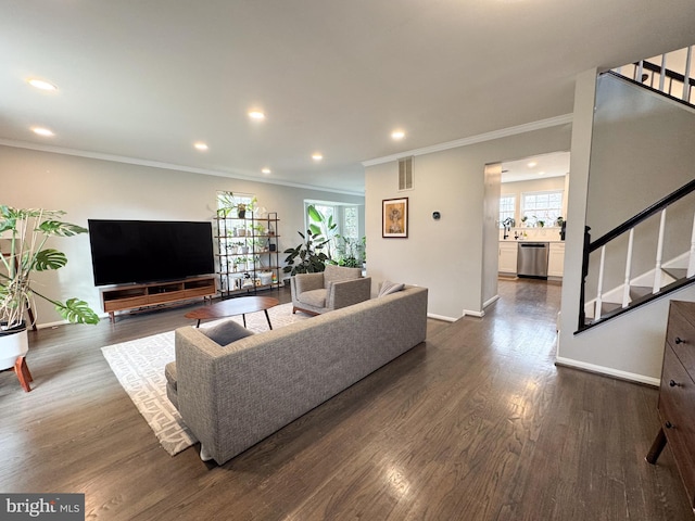 living area with baseboards, visible vents, stairway, and dark wood-style flooring