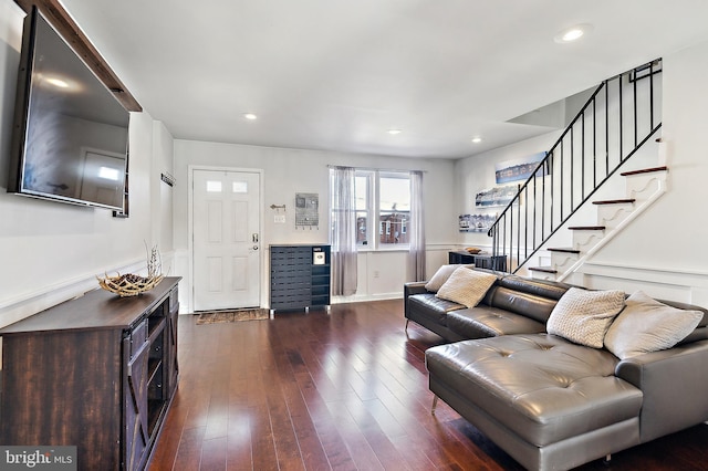 living room with recessed lighting, dark wood finished floors, and stairs