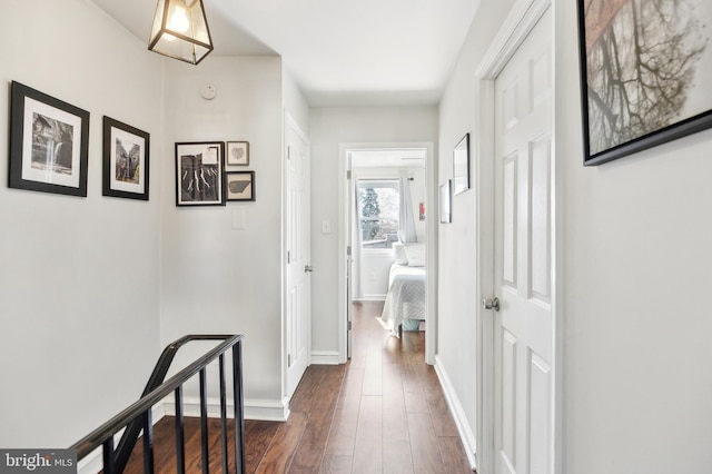 hallway with dark wood-style floors and baseboards