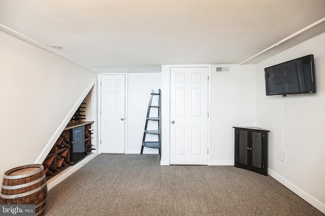 interior space with carpet, visible vents, and baseboards