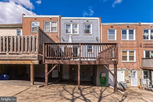 back of house featuring a deck and central AC unit