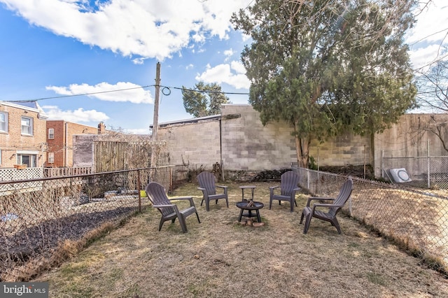 view of yard featuring fence private yard and a fire pit