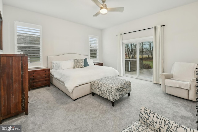 bedroom with a ceiling fan, light colored carpet, and access to exterior