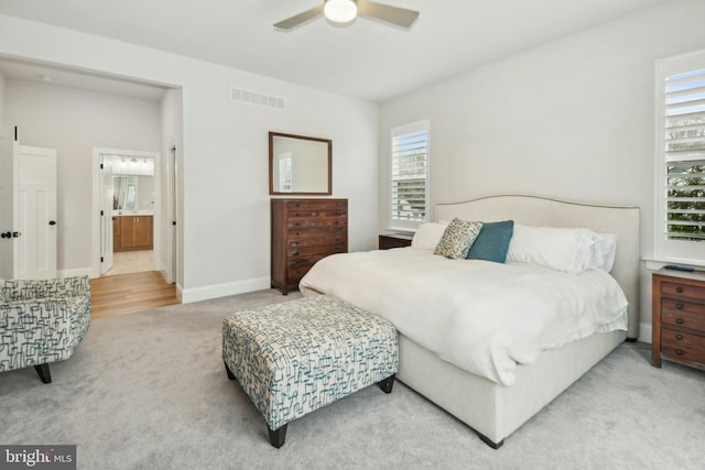 carpeted bedroom with baseboards, visible vents, and a ceiling fan