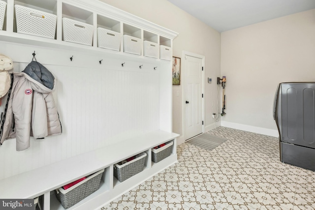 mudroom with washer / dryer, baseboards, and light floors