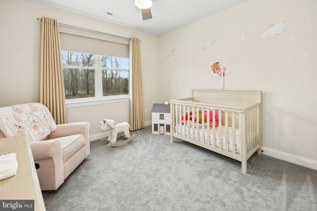 bedroom featuring carpet, baseboards, visible vents, and a nursery area