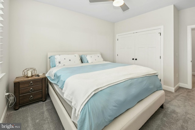 bedroom with dark colored carpet, a closet, a ceiling fan, and baseboards