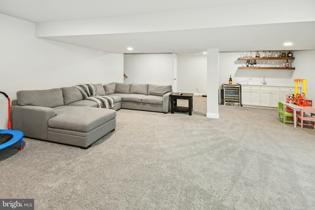 living room with recessed lighting, beverage cooler, wet bar, and light colored carpet