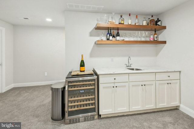 bar featuring light carpet, visible vents, wine cooler, indoor wet bar, and a sink