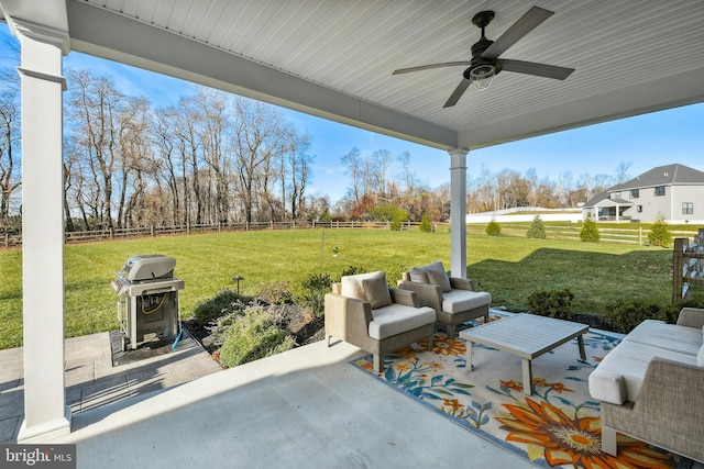 view of patio with an outdoor living space, a fenced backyard, a ceiling fan, and a grill