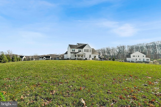 view of yard featuring a rural view and fence