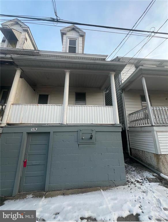 view of snow covered exterior featuring a balcony