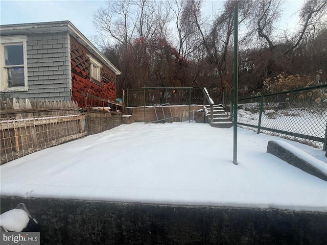 snowy yard with fence