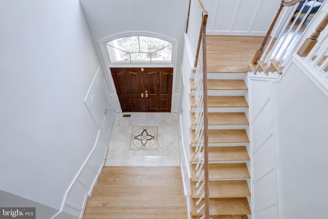 foyer with stairs and a decorative wall