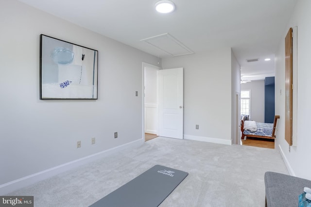 workout room with baseboards, carpet, attic access, and visible vents