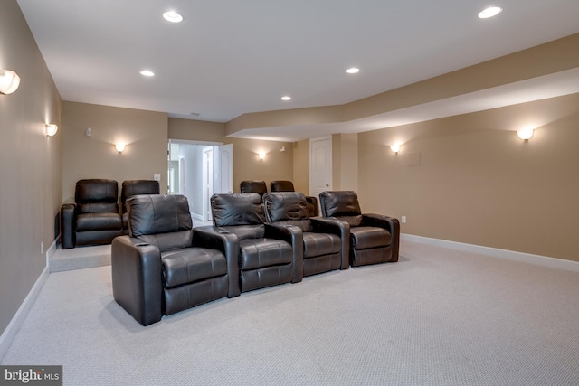 carpeted home theater room with recessed lighting and baseboards