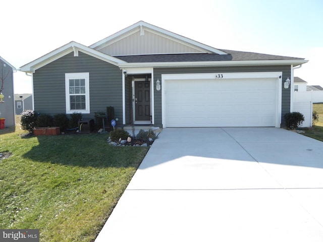 single story home featuring a front yard, driveway, and an attached garage