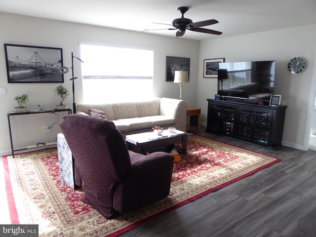 living area with ceiling fan, baseboards, and wood finished floors