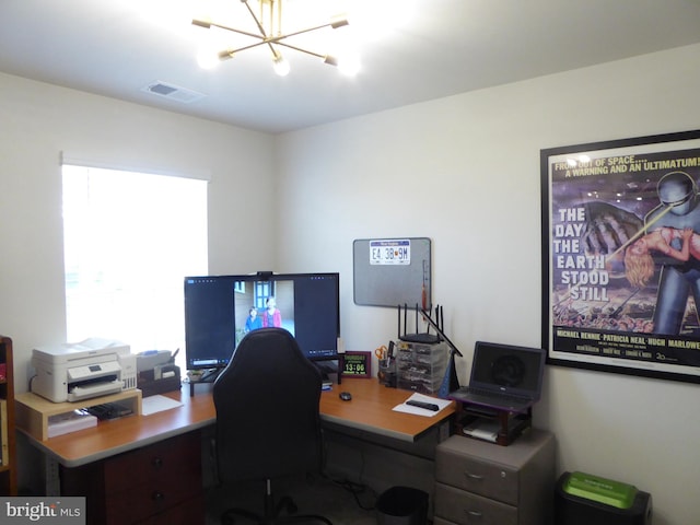 office space featuring visible vents and a notable chandelier