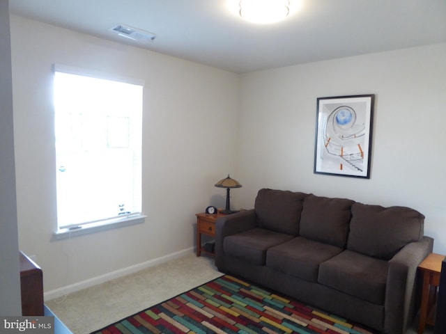 carpeted living room featuring baseboards and visible vents