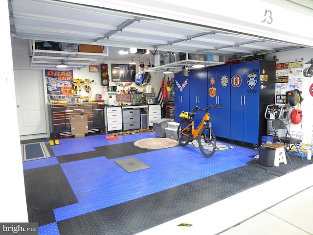 garage featuring a garage door opener and a workshop area