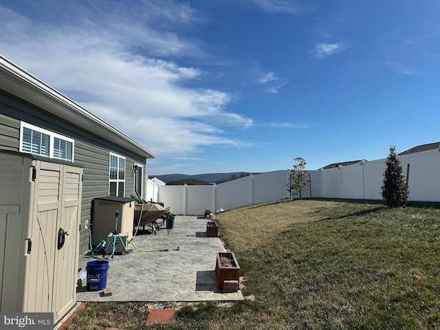 view of yard featuring a patio area and a fenced backyard