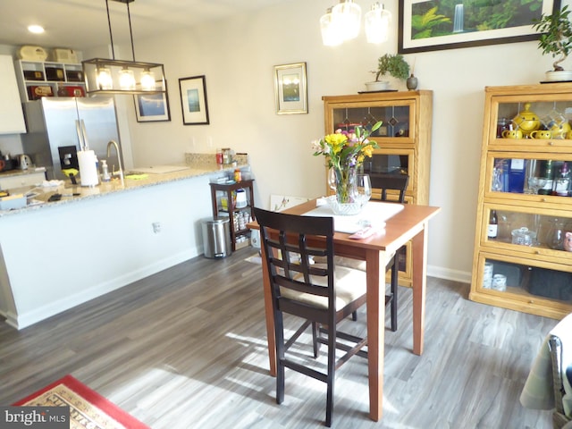 dining room featuring dark wood finished floors and baseboards