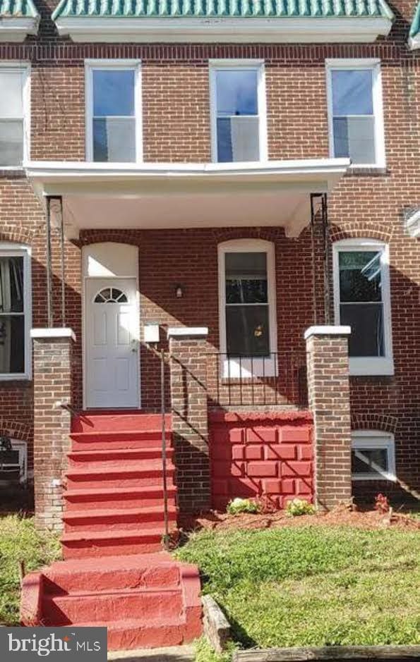 view of front of house featuring brick siding