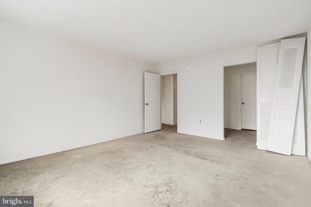 unfurnished bedroom with visible vents and unfinished concrete floors