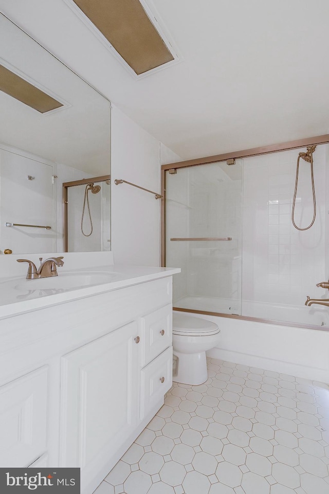 full bathroom with toilet, bath / shower combo with glass door, and vanity