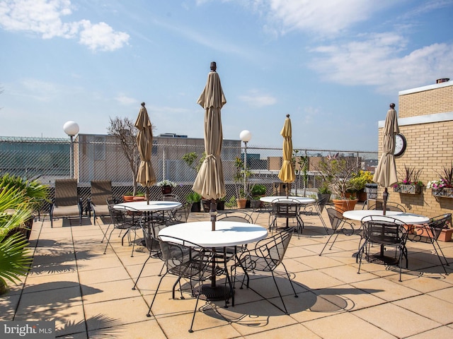 view of patio / terrace featuring outdoor dining area and fence