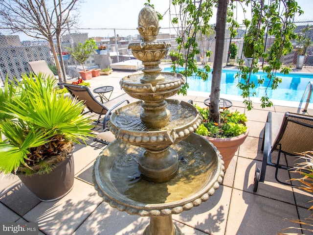 view of patio featuring fence and an outdoor pool