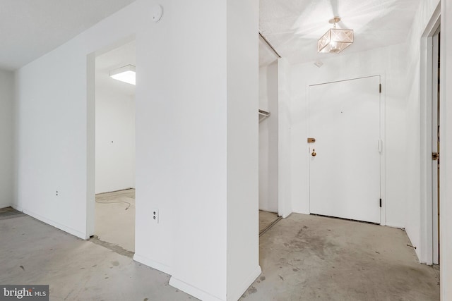 foyer entrance featuring concrete floors