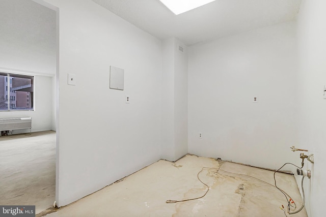 empty room with visible vents and unfinished concrete flooring