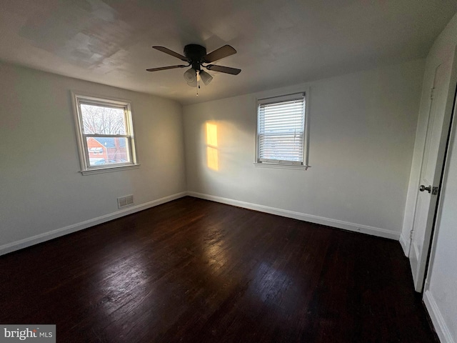 5716 Willowton Ave, Baltimore, MD 21239 - unfurnished bedroom with a ceiling fan, baseboards, dark wood finished floors, and visible vents