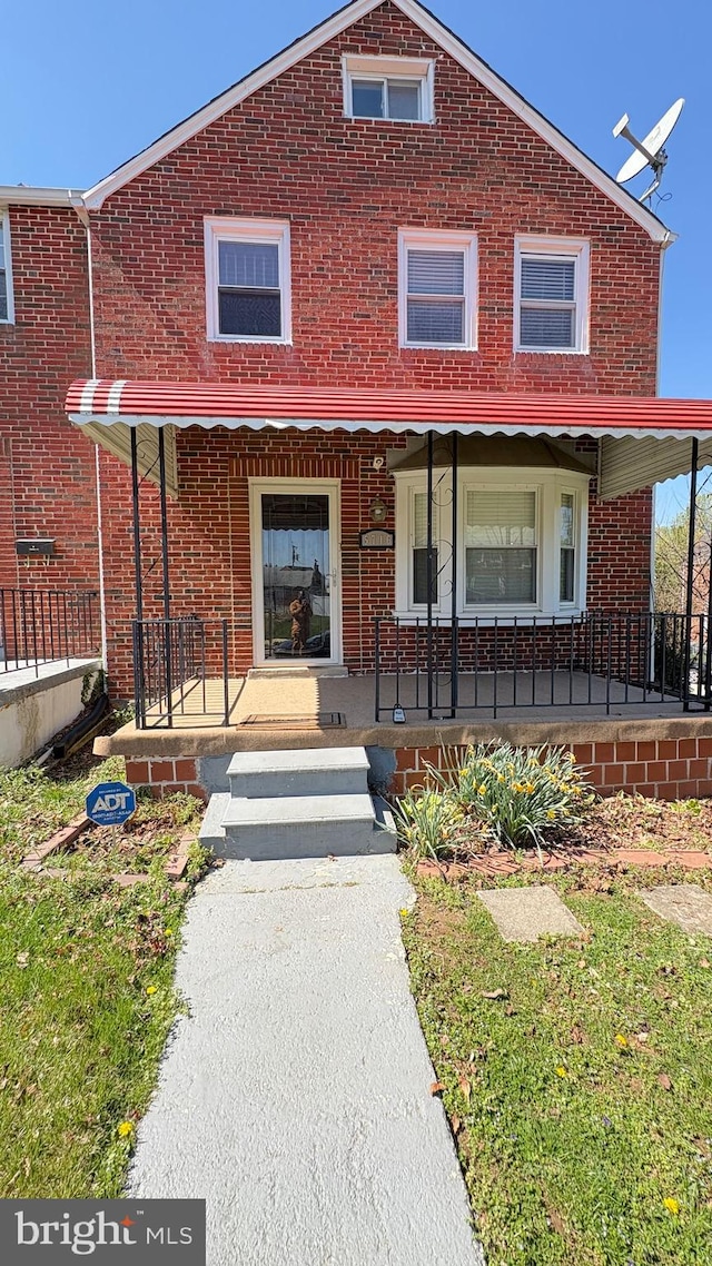 5716 Willowton Ave, Baltimore, MD 21239 - view of property with brick siding and a porch