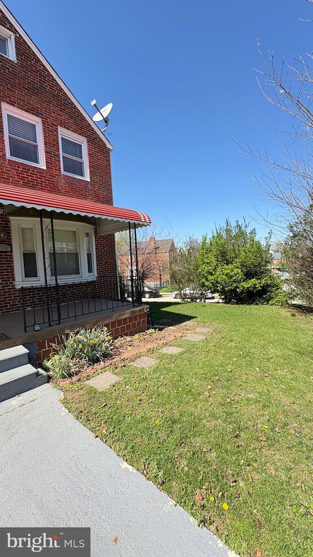5716 Willowton Ave, Baltimore, MD 21239 - exterior space with a lawn, covered porch, and brick siding