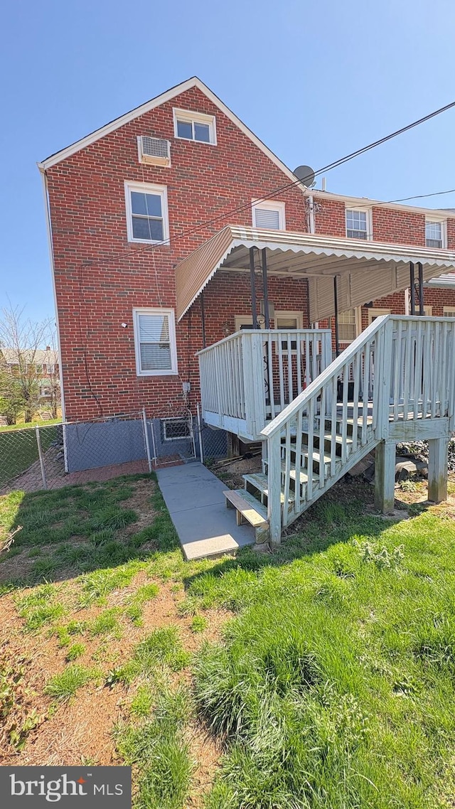 5716 Willowton Ave, Baltimore, MD 21239 - rear view of property featuring a patio, a yard, a wooden deck, and brick siding