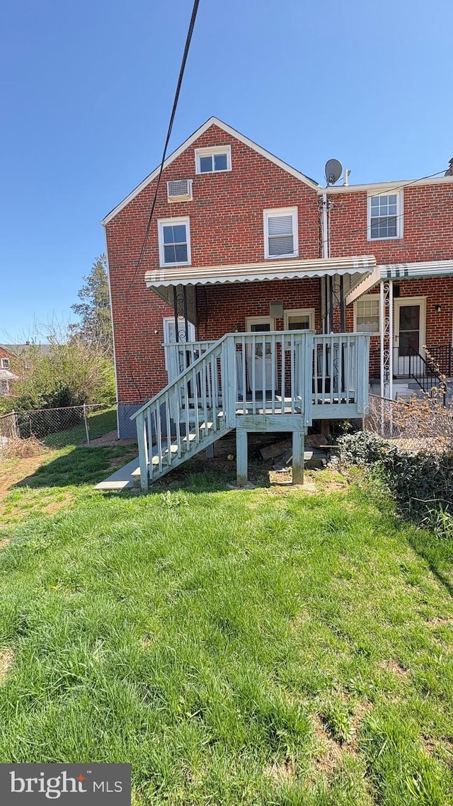 5716 Willowton Ave, Baltimore, MD 21239 - rear view of house featuring a yard, brick siding, and fence