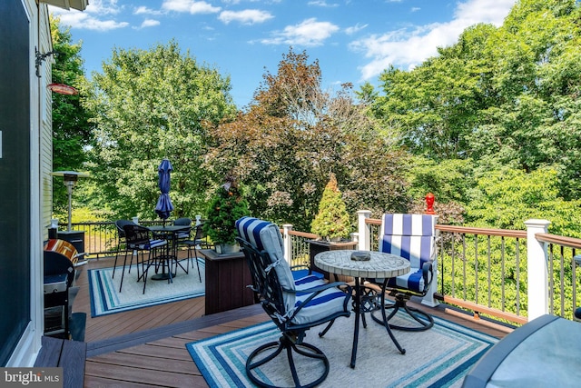 wooden terrace featuring outdoor dining space