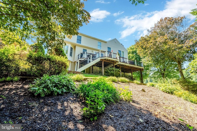 back of house with stairway and a wooden deck