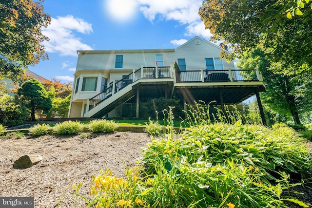 back of house with a deck and stairway