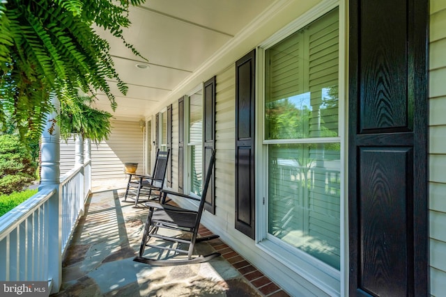 balcony featuring a porch and a sunroom