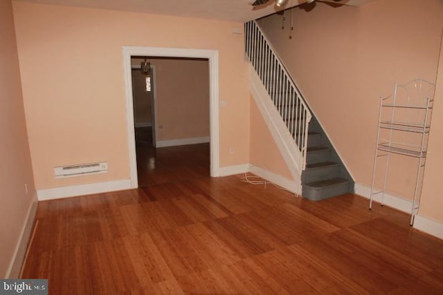 stairway featuring baseboards and wood finished floors