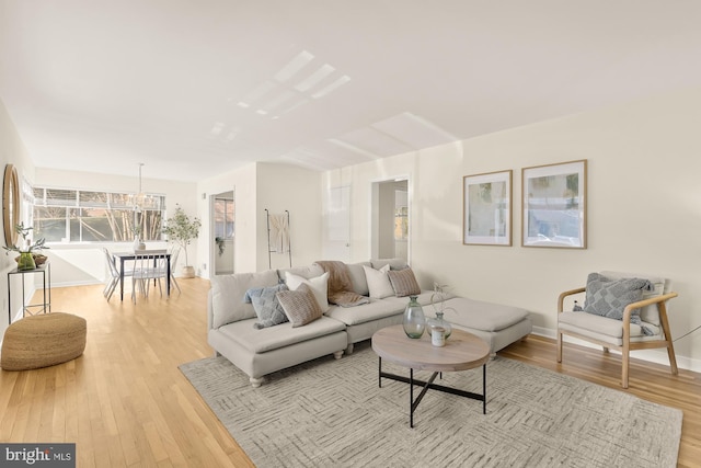 living room featuring light wood finished floors and baseboards